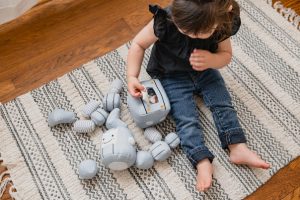 A child playing with a Wonder & Wise Tot Bot.